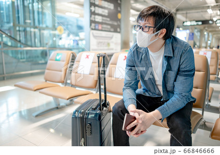 Asian man tourist wearing mask in airport terminal 66846666