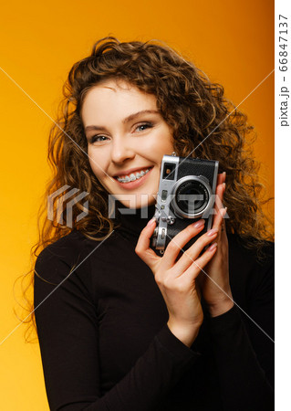 Beautiful girl with photo camera isolated on Beautiful girl with photo camera isolated on 66847137