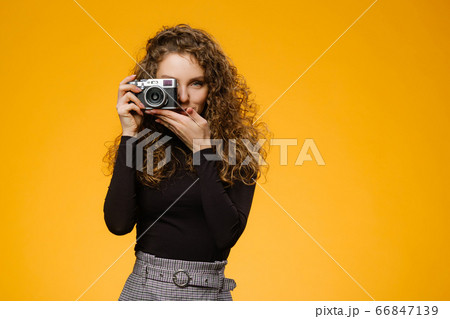 Beautiful girl with photo camera isolated on 66847139