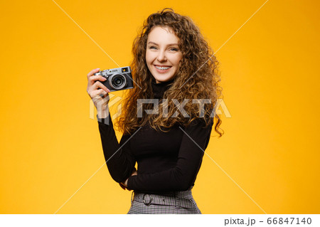 Pretty girl with photocamera and healthy smile 66847140