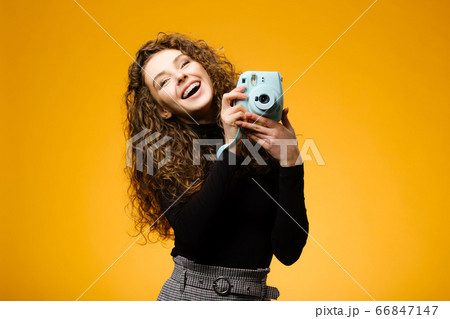 Beautiful girl with photo camera isolated on Beautiful girl with photo camera isolated on 66847147