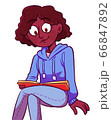 Young female student reading book for fun or enjoying studying 66847892