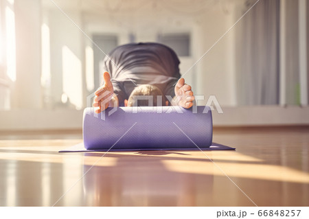 Young man doing exercise with muscle therapy foam roller Young man doing exercise with muscle therapy foam roller 66848257
