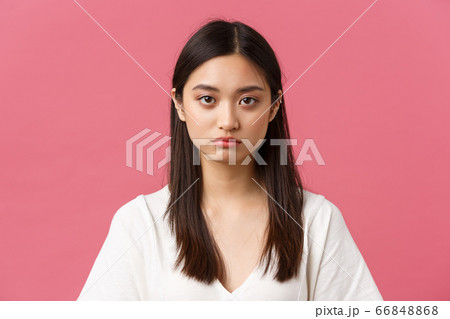 Beauty, people emotions and summer leisure concept. Close-up of gloomy and sad, tired young asian female employee looking at camera reluctant, standing distressed over pink background 66848868