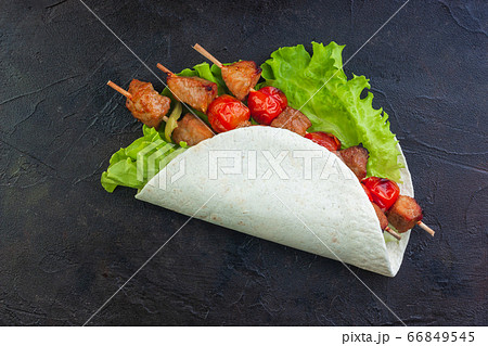 Pork on skewers with vegetables on lettuce and Pork on skewers with vegetables on lettuce and 66849545