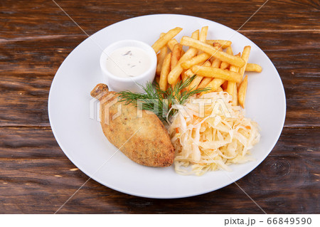 Chicken cutlet with french fries, sauerkraut and sauce 66849590