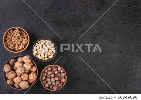 Different nuts in dishes, walnuts, hazelnuts, 66849690