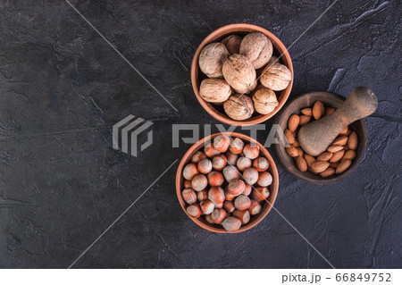 Nuts, walnuts, hazelnuts and mintal on a dark Nuts, walnuts, hazelnuts and mintal on a dark 66849752