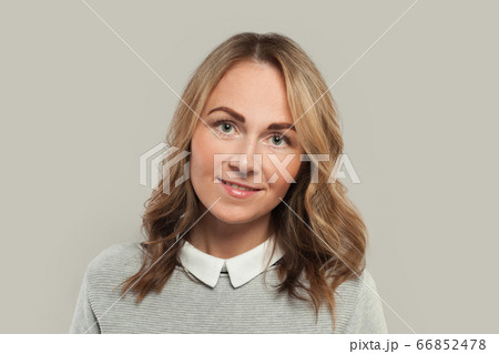Optimistic woman smiling on white background 66852478