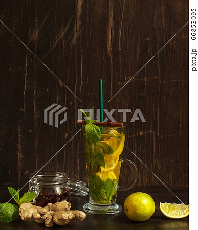 Refreshing drink that is good for digestion with lemon, ginger and mint on a dark background Refreshing drink that is good for digestion with lemon, ginger and mint on a dark background 66853095