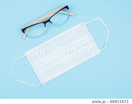 Goggles and a medical mask on a blue background. Goggles and a medical mask on a blue background. 66853872