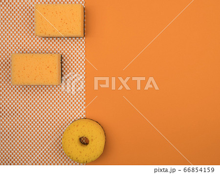 Accessories for washing dishes on an orange background. Accessories for washing dishes on an orange background. 66854159