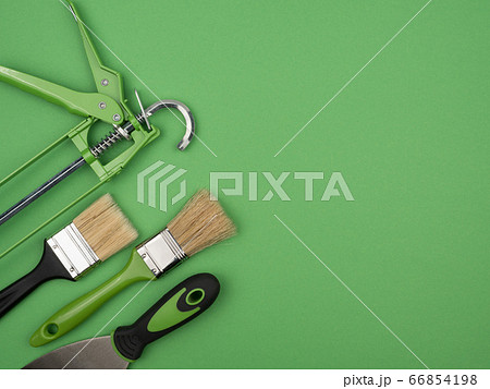 Green painting tool on a green background. The view from the top. Green painting tool on a green background. The view from the top. 66854198