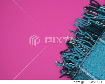 Warm turquoise plaid on a bright pink background. Warm turquoise plaid on a bright pink background. 66854421