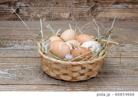 Basket with homemade chicken eggs on a wooden background. Basket with homemade chicken eggs on a wooden background. 66854666