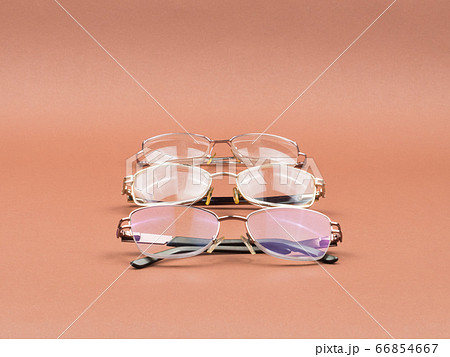 Glasses - an accessory for better vision on a brown background. 66854667