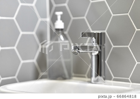 close up of water tap with liquid soap on sink close up of water tap with liquid soap on sink 66864818