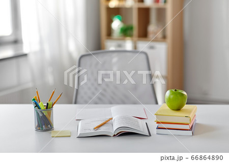 books, apple and school supplies on table at home books, apple and school supplies on table at home 66864890