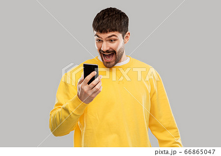 happy smiling young man with smartphone happy smiling young man with smartphone 66865047