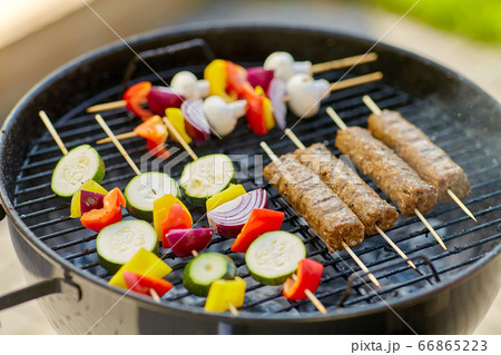 barbecue meat and vegetables roasting on grill barbecue meat and vegetables roasting on grill 66865223
