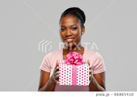happy african american woman with birthday present 66865410