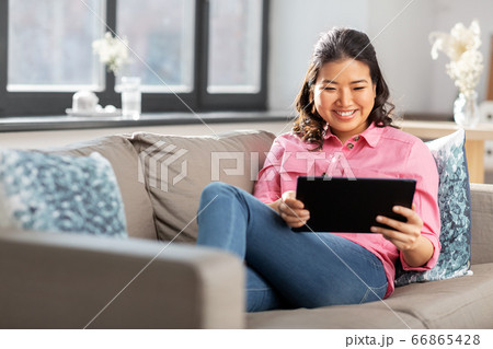asian young woman with tablet pc computer at home asian young woman with tablet pc computer at home 66865428