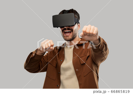 happy smiling young man in vr glasses happy smiling young man in vr glasses 66865819