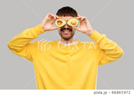happy young man with avocado instead of eyes happy young man with avocado instead of eyes 66865972