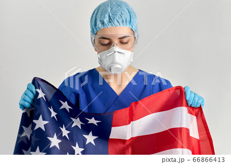 doctor in goggles and mask holding flag of america doctor in goggles and mask holding flag of america 66866413