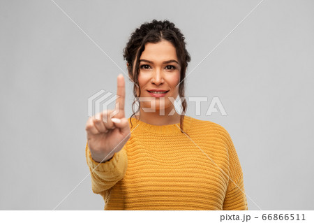 happy woman in pullover showing one finger happy woman in pullover showing one finger 66866511