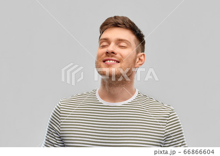smiling young man in striped t-shirt breathing smiling young man in striped t-shirt breathing 66866604