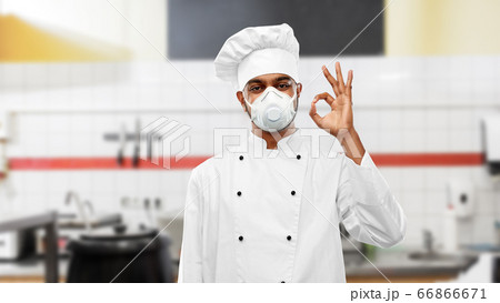 chef in respirator showing ok sign at kitchen chef in respirator showing ok sign at kitchen 66866671