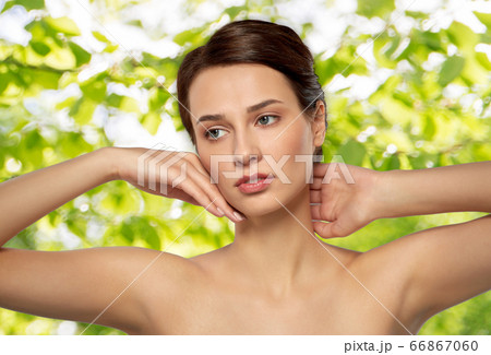 beautiful young woman touching her face beautiful young woman touching her face 66867060