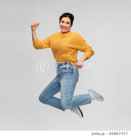 happy young woman with pierced nose jumping happy young woman with pierced nose jumping 66867457