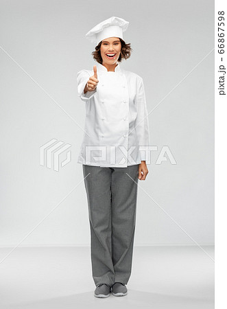 smiling female chef in toque showing thumbs up smiling female chef in toque showing thumbs up 66867598