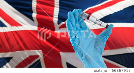 hand holding beaker with coronavirus blood test hand holding beaker with coronavirus blood test 66867915