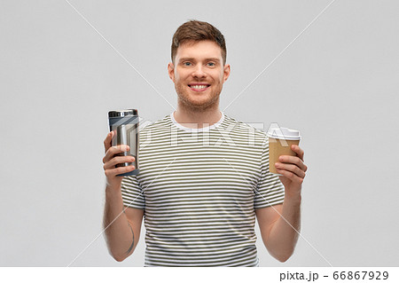 man comparing thermo cup or tumbler and coffee cup man comparing thermo cup or tumbler and coffee cup 66867929