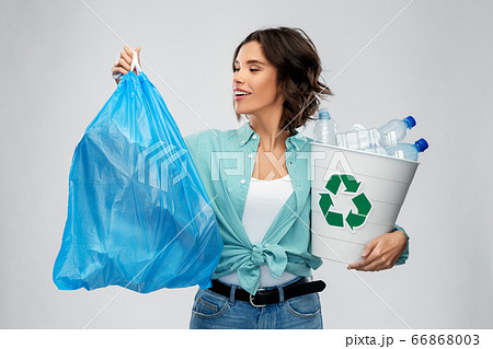 smiling woman sorting plastic waste and trash bag smiling woman sorting plastic waste and trash bag 66868003