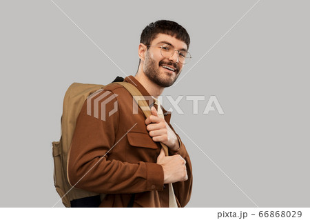smiling young man in glasses with backpack 66868029