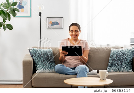african american woman with tablet pc at home african american woman with tablet pc at home 66868114