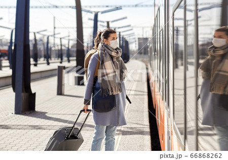 woman in protective face mask at railway station woman in protective face mask at railway station 66868262