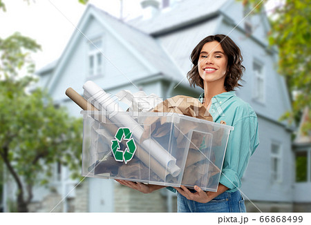 happy smiling young woman sorting paper waste 66868499
