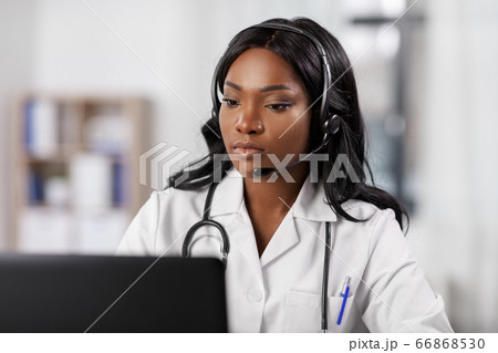 african doctor with headset and laptop at hospital 66868530