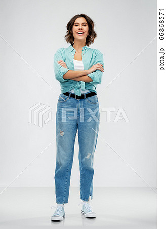 smiling young woman in turquoise shirt and jeans smiling young woman in turquoise shirt and jeans 66868574
