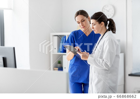 doctor and nurse with clipboard at hospital 66868662