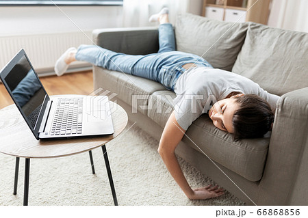 bored woman with laptop lying on sofa at home bored woman with laptop lying on sofa at home 66868856
