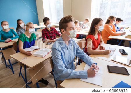 group of students in masks at school lesson 66868955