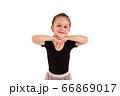 Portrait of cute little girl wearing dance suit, smiling and propping up her head with hands , isolated on white background 66869017