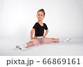Little girl doing stretching and gymnastic exercises on a white background. 66869161