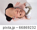 Little girl doing stretching and gymnastic exercises on a white background. 66869232